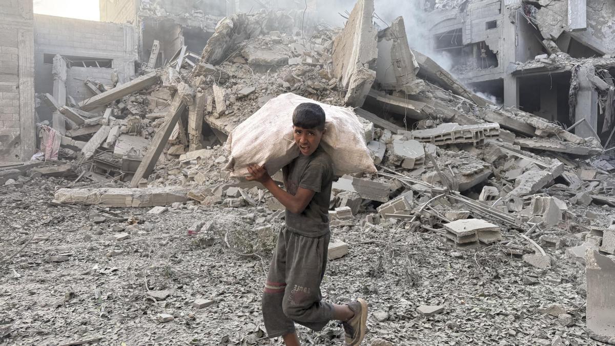 Una persona camina por los escombros tras uno de los ataques lanzados el domingo 19 de octubre de 2025 por Israel en Bureij, Gaza