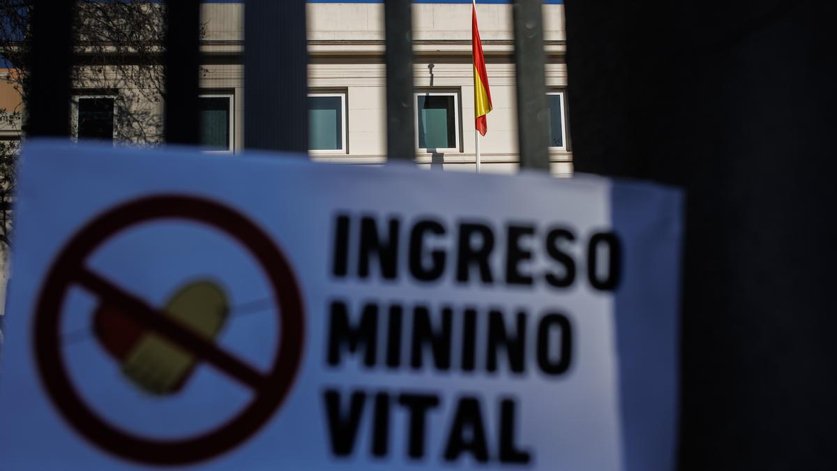 Foto de archivo de un cartel en el que se lee 'Ingreso Mínimo Vital' en las rejas del Ministerio de Inclusión y Seguridad Social.