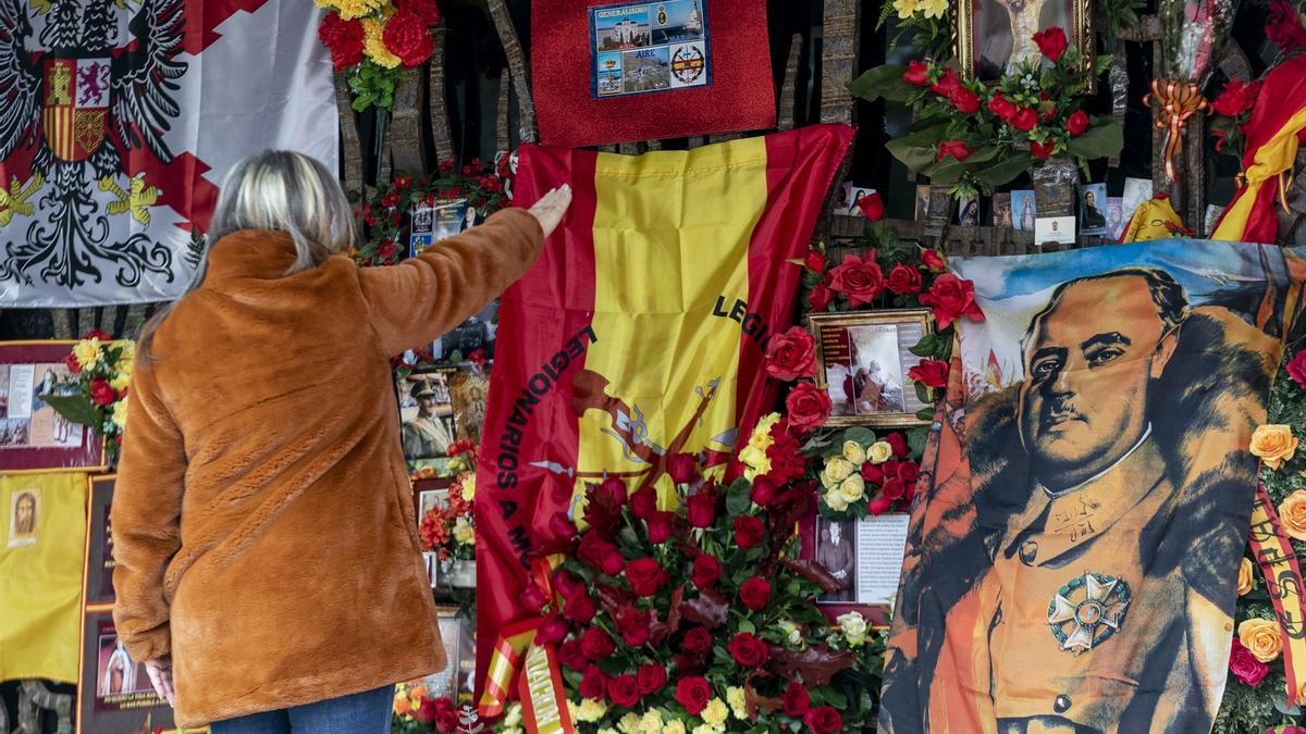 Una mujer realiza el saludo fascista o ante el panteón de la familia Franco, en el cementerio de Mingorrubio, a 20 de noviembre de 2021, en El Pardo, Madrid (España).