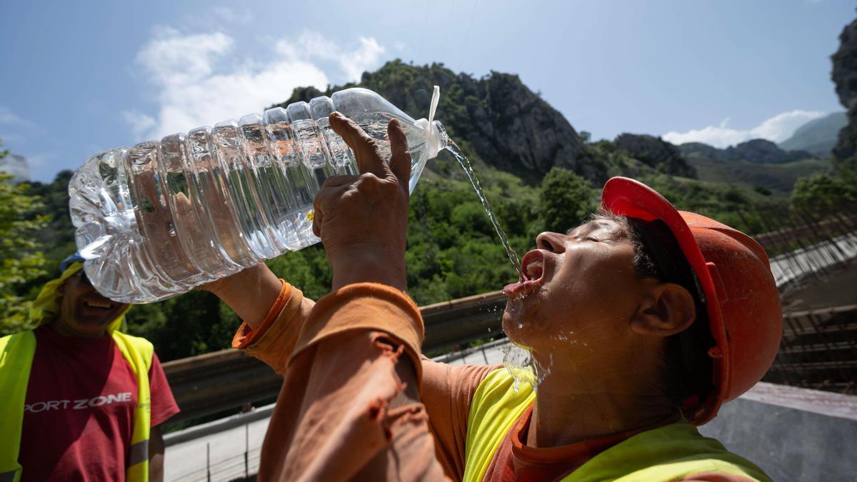 Un trabajador se refresca este martes en el desfiladero de La Hermida (Cantabria).