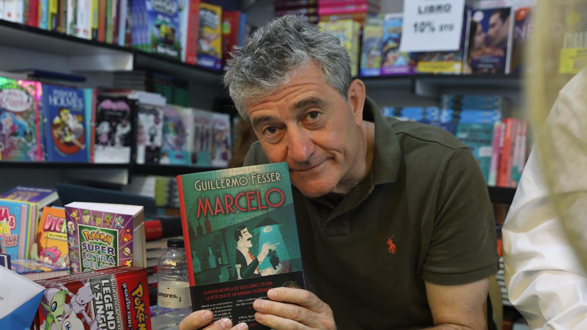 Guillermo Fesser sostiene un ejemplar de su libro 'Marcelo' en la Feria del Libro de Madrid.