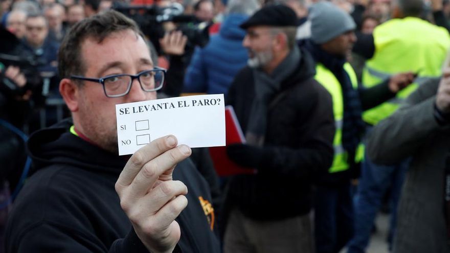 Un taxista muestra una de las papeletas mientras espera el comienzo de la votación en Barcelona.