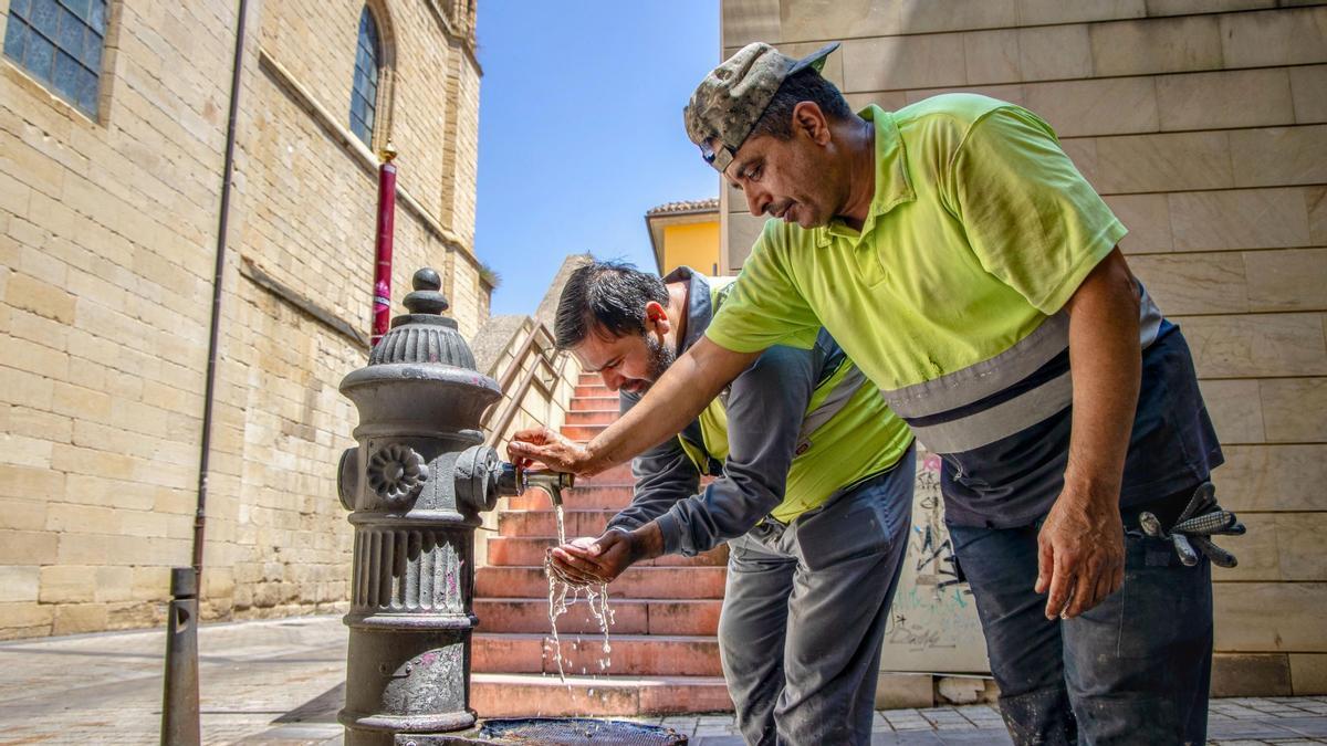 Unos trabajadores se refrescan en una fuente en Logroño, el 6 de agosto.