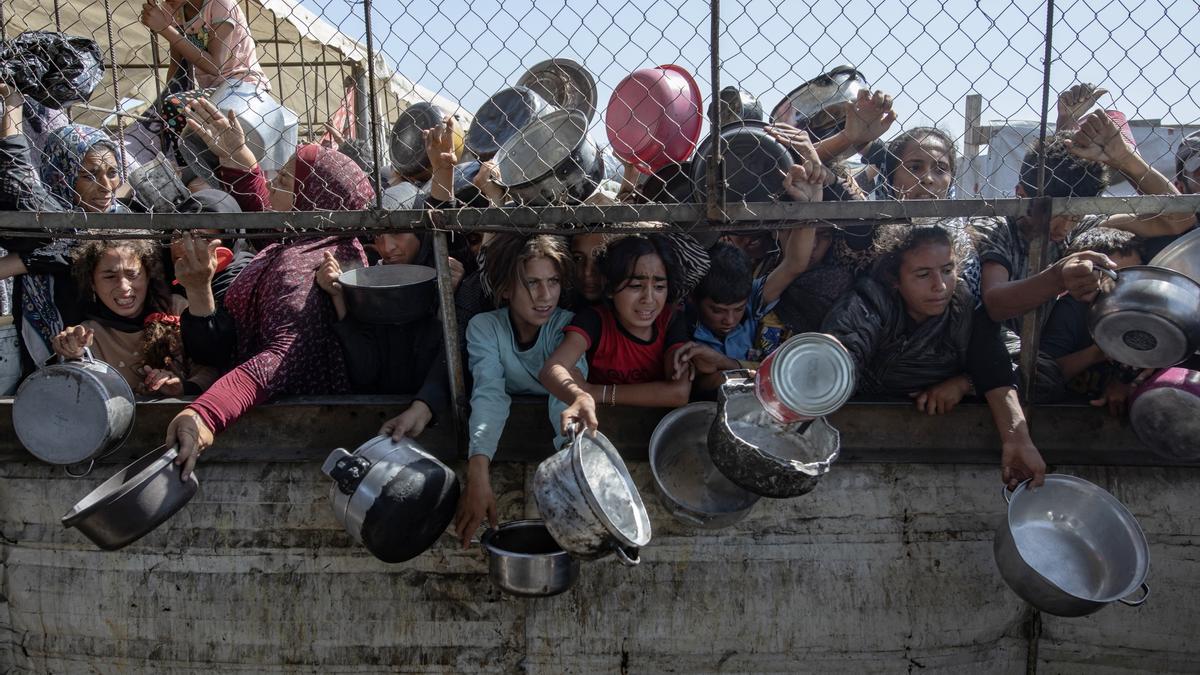 Palestinos frente a un comedor para recibir alimento en Khan Younis, en el sur de la Franja de Gaza.